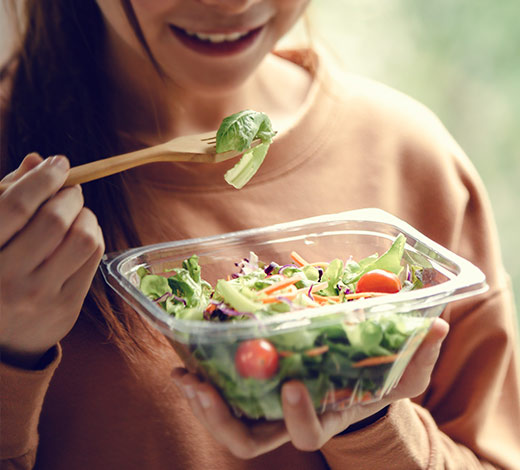Image of woman eating a salad