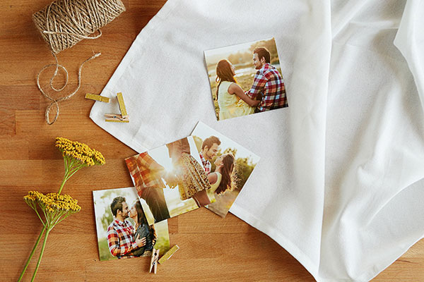 Square prints of a couple, plus flowers, gold clothespins and natural jute twine