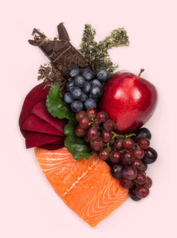 Salmon, grapes, beets, blueberries, apple, chocolate, and green tea in the shape of an anatomical heart