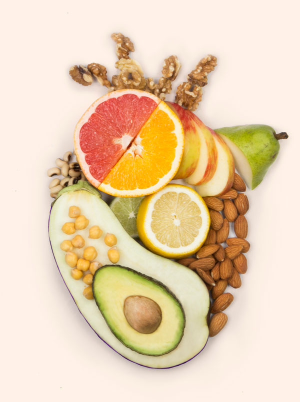 Walnuts, almonds, chick peas, eggplant, apples, grapefruit, lemon, lime, pear, and avocado in the shape of an anatomical heart