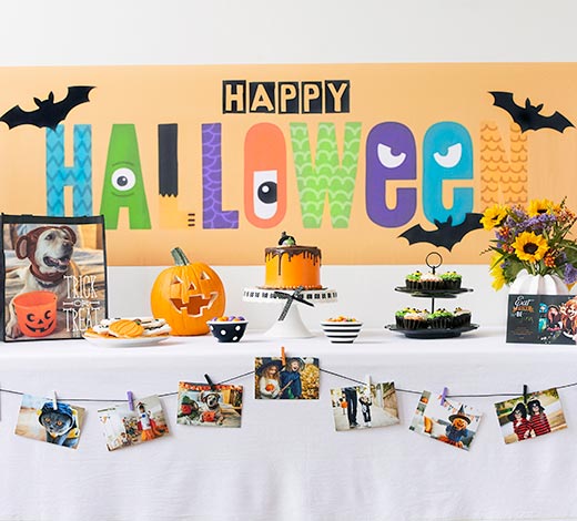 Table with festive Halloween decorations and a banner that says "Happy Halloween"