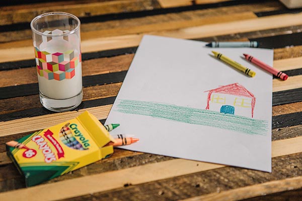A child's crayon drawing with crayons on paper
