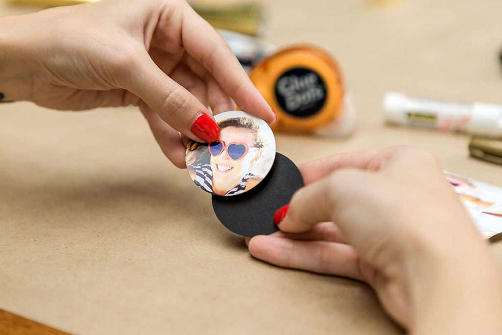 Gluing the cut out photo to a black circle