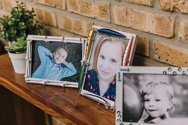 Father's Day hobby frame DIY project as a gift for dad. Three frames decorated with golf tees, fishing lures, and nuts and bolts. Photos of the kids in the frames.