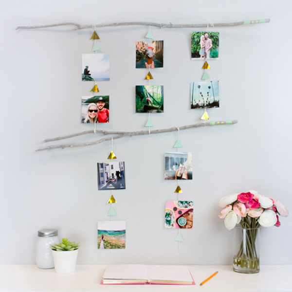 Dorm room photo mobile. Photos displayed on string between two painted sticks.
