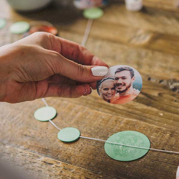 Placing the photo on top of the glued card stock circle and the twine.