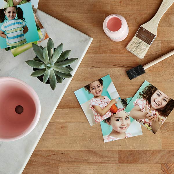 Mother's Day photo planter materials you will need: flower pot, paint and paint brush, 4x4 or 4x6 prints, sponge brush and decoupage adhesive.